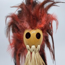Voodoo head with raffia beard and feathers